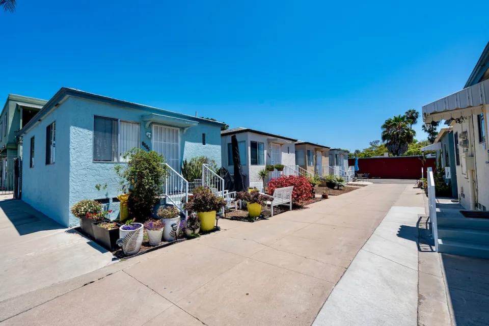 Colorful bright blue small houses with decorative cacti in courtyard in San Diego, California.
